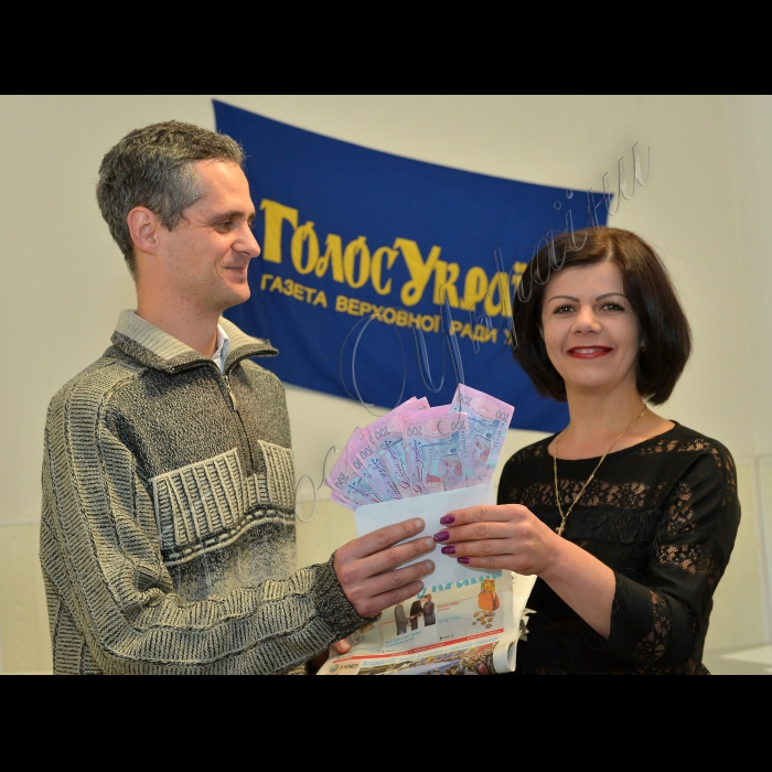 Вручення грошового призу Борису Сокуру з м. Сніжне Донецької обл.
Приз передплатнику виграв батько Сокура, Михайло, але він вже пенсіонер і приїхати не зміг
Вручає головний бухгалтер газети Голос України Ірина Лозова
